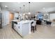 Open kitchen with island, stainless steel appliances, and views into the living room at 405 Amola Way, Howey In The Hills, FL 34737