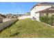 Spacious backyard with a large grassy area, privacy fence, and covered patio at 405 Amola Way, Howey In The Hills, FL 34737