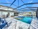 Luxury pool and spa with screened enclosure and outdoor kitchen at 405 Amola Way, Howey In The Hills, FL 34737