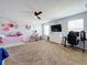Cozy bedroom with a bed, dresser and gaming setup at 405 Amola Way, Howey In The Hills, FL 34737
