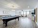 Large game room with pool table and comfortable seating at 405 Amola Way, Howey In The Hills, FL 34737