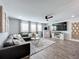 Bright and airy game room featuring a sectional sofa and large TV at 405 Amola Way, Howey In The Hills, FL 34737