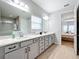 Double vanity bathroom with a view into the bedroom at 405 Amola Way, Howey In The Hills, FL 34737