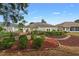 Landscaped backyard with a stone pathway and manicured hedges at 4803 Sawgrass Lake Cir, Leesburg, FL 34748