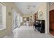 Spacious sunroom with piano and access to backyard at 4803 Sawgrass Lake Cir, Leesburg, FL 34748