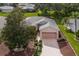 Aerial view of the house, showing landscaping and driveway at 4803 Sawgrass Lake Cir, Leesburg, FL 34748