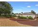 Landscaped backyard with gravel and red mulch pathways at 4803 Sawgrass Lake Cir, Leesburg, FL 34748