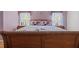 Main bedroom with wooden sleigh bed and nightstands at 4803 Sawgrass Lake Cir, Leesburg, FL 34748
