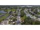 Aerial view showcasing homes near a golf course and lake at 4803 Sawgrass Lake Cir, Leesburg, FL 34748