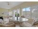 Sunroom with wicker furniture and view of backyard at 4803 Sawgrass Lake Cir, Leesburg, FL 34748
