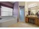 Spa-like bathroom with soaking tub, walk-in shower, and dual vanity at 4803 Sawgrass Lake Cir, Leesburg, FL 34748