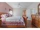 Main bedroom with wood furniture and neutral decor at 4803 Sawgrass Lake Cir, Leesburg, FL 34748