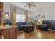 Bright Gathering room with hardwood floors, comfy seating, and built-in shelving at 4803 Sawgrass Lake Cir, Leesburg, FL 34748