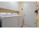Laundry room with washer, dryer, and ample cabinet storage at 4803 Sawgrass Lake Cir, Leesburg, FL 34748