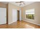 Bright bedroom with hardwood floors, ceiling fan, and large closet at 9442 Cr 674, Bushnell, FL 33513