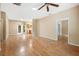 Living room with hardwood floors, and views into kitchen and other rooms at 9442 Cr 674, Bushnell, FL 33513