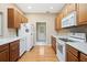 Kitchen with wood cabinets, appliances, and access to laundry at 9442 Cr 674, Bushnell, FL 33513