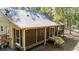 Large screened porch with wooden railings and steps leading down to the yard at 9442 Cr 674, Bushnell, FL 33513