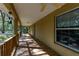 Long front porch with wooden railings and a ceiling fan at 9442 Cr 674, Bushnell, FL 33513