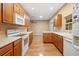 Open kitchen with oak cabinets, island, and hardwood floors at 9442 Cr 674, Bushnell, FL 33513