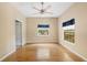 Bedroom with hardwood floors, ceiling fan and window with wooded views at 9442 Cr 674, Bushnell, FL 33513