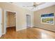 Bedroom with hardwood floors, ceiling fan, and walk-in closet at 9442 Cr 674, Bushnell, FL 33513