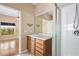 Bathroom with vanity, shower, and view into bedroom at 9442 Cr 674, Bushnell, FL 33513