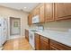 Bright kitchen with oak cabinets, white appliances, and wood flooring at 9442 Cr 674, Bushnell, FL 33513