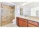 Bathroom with a walk-in shower, tile flooring and a wood vanity at 1429 Bluebeard Ct, The Villages, FL 32163