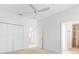 Bedroom with ceiling fan, carpet, and en-suite bathroom access at 1429 Bluebeard Ct, The Villages, FL 32163