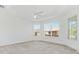Large bedroom with plush carpet, ceiling fan, and abundant natural light at 1429 Bluebeard Ct, The Villages, FL 32163
