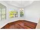 Bright dining room featuring hardwood floors and large windows at 1429 Bluebeard Ct, The Villages, FL 32163