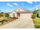 One-story house with a two-car garage and landscaped yard at 1429 Bluebeard Ct, The Villages, FL 32163