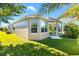 Tan house with a large backyard and sunroom at 1429 Bluebeard Ct, The Villages, FL 32163
