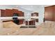 Spacious kitchen with granite countertops and dark wood cabinets at 1429 Bluebeard Ct, The Villages, FL 32163