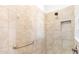 Large walk-in shower with neutral tile and grab bar at 1429 Bluebeard Ct, The Villages, FL 32163