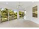 Bright sunroom with sliding glass doors and a ceiling fan at 1429 Bluebeard Ct, The Villages, FL 32163