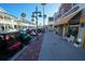 Spanish Springs Town Center street view with shops and parked golf carts at 1725 Oak Forest Dr, The Villages, FL 32162