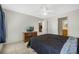 Main bedroom with a dresser, a TV, and a view into the kitchen at 40335 Palm St, Lady Lake, FL 32159