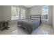 Bedroom with a double bed, neutral walls, and two windows at 40335 Palm St, Lady Lake, FL 32159