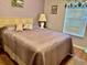 Guest bedroom with a double bed and lavender bedding at 5006 El Destino Dr, Leesburg, FL 34748