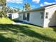 Back exterior view showing a patio and grassy yard at 5006 El Destino Dr, Leesburg, FL 34748