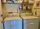 Bright laundry room with washer, dryer, and ample shelving at 5006 El Destino Dr, Leesburg, FL 34748