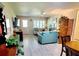 Bright and airy living room featuring light colored floors and comfy teal couch at 8284 Sw 90Th St # C, Ocala, FL 34481