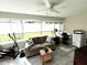 Bright sunroom featuring a couch, exercise equipment, and large windows at 8284 Sw 90Th St # C, Ocala, FL 34481