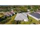 House's rear and the surrounding neighborhood from an aerial perspective at 1006 Sayle St, The Villages, FL 32162
