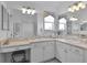 Bathroom with double sinks, vanity, and large mirror at 1006 Sayle St, The Villages, FL 32162
