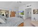 Main bedroom with king bed, access to backyard, and large TV at 1006 Sayle St, The Villages, FL 32162