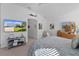 Main bedroom with large TV, dresser, and walk-in closet at 1006 Sayle St, The Villages, FL 32162