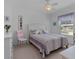 Bright bedroom with double bed, dresser, and window at 1006 Sayle St, The Villages, FL 32162